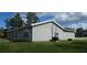 Back exterior view of this home with siding, windows and roof with grass and blue skies at 13650 Sw 43Rd Cir, Ocala, FL 34473