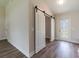View of the foyer features a modern barn door and stylish wood-look floors at 13650 Sw 43Rd Cir, Ocala, FL 34473