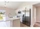 Bright open kitchen features white cabinets and a stainless steel refrigerator at 13650 Sw 43Rd Cir, Ocala, FL 34473
