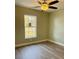 Cozy bedroom featuring a window, ceiling fan, and wood-look flooring at 1522 Kettles Ave, Lakeland, FL 33805