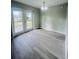 Cozy dining area with french doors, modern lighting, and gray wood-look flooring at 1522 Kettles Ave, Lakeland, FL 33805