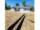 Charming single-story home with a well-maintained lawn and neutral gray exterior at 1522 Kettles Ave, Lakeland, FL 33805