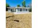 Charming single-story home with a well-maintained lawn and neutral gray exterior at 1522 Kettles Ave, Lakeland, FL 33805