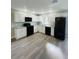 Modern kitchen featuring sleek black appliances, granite countertops, and updated white cabinetry at 1522 Kettles Ave, Lakeland, FL 33805