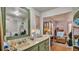 Bathroom with white vanity, marble countertop, and integrated sink; laundry nearby at 1610 Reynolds Rd # 50, Lakeland, FL 33801