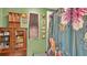 Green bathroom featuring a decorative cabinet and floral shower curtain at 1610 Reynolds Rd # 50, Lakeland, FL 33801