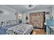 Comfortable bedroom with a unique wooden barn door style closet and view to kitchen at 1610 Reynolds Rd # 50, Lakeland, FL 33801