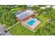 Aerial view of community pool, surrounded by lush landscaping and seating areas, offers a relaxing retreat at 1610 Reynolds Rd # 50, Lakeland, FL 33801