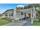 Charming home with a covered parking area and a delightful outdoor patio featuring colorful furniture at 1610 Reynolds Rd # 50, Lakeland, FL 33801