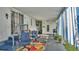 Relax on the patio with cozy seating, a grill, and striped curtain accents for a stylish outdoor experience at 1610 Reynolds Rd # 50, Lakeland, FL 33801