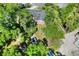 Aerial view of the property showcasing lush landscaping, a spacious lot, and a serene neighborhood setting at 1655 John Arthur Way, Lakeland, FL 33803