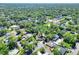 Aerial view of a home nestled within a lush, green neighborhood with mature trees at 1655 John Arthur Way, Lakeland, FL 33803