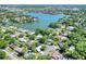 A lovely aerial view shows a lake and green foliage surrounding a charming neighborhood with single Gathering homes at 1655 John Arthur Way, Lakeland, FL 33803