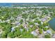 An aerial view shows this house nestled in a charming neighborhood with mature trees at 1655 John Arthur Way, Lakeland, FL 33803