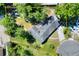 Aerial view shows the property's location within a well-maintained lawn and mature trees at 1655 John Arthur Way, Lakeland, FL 33803