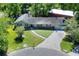 An aerial view of a single story home, showcasing the landscaped yard and surrounding neighborhood at 1655 John Arthur Way, Lakeland, FL 33803
