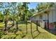 Fenced-in backyard with a black chain-link fence providing security and a great view of the surrounding greenery at 1655 John Arthur Way, Lakeland, FL 33803