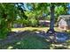 Expansive backyard with mature trees, a shed, playground, and lush green lawn, great for families at 1655 John Arthur Way, Lakeland, FL 33803