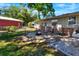 Spacious backyard featuring a cozy fire pit area and established landscaping for outdoor enjoyment at 1655 John Arthur Way, Lakeland, FL 33803