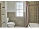 Bathroom with tub shower combo and window at 1655 John Arthur Way, Lakeland, FL 33803