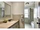 Bathroom featuring a granite vanity, decorative accents, and tiled shower-tub combo at 1655 John Arthur Way, Lakeland, FL 33803