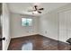 Bedroom with hardwood floors, ceiling fan, and natural light from the window at 1655 John Arthur Way, Lakeland, FL 33803