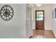 Inviting foyer featuring tile flooring, front door with glass, and a decorative clock, creating a warm entry at 1655 John Arthur Way, Lakeland, FL 33803