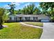Charming single-story home featuring a well-maintained lawn, brick accents, and attached garage, perfect for suburban living at 1655 John Arthur Way, Lakeland, FL 33803