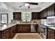 Well-lit kitchen with dark wood cabinets and granite countertops at 1655 John Arthur Way, Lakeland, FL 33803