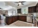 Spacious kitchen featuring dark wood cabinets, stainless appliances, and an island at 1655 John Arthur Way, Lakeland, FL 33803