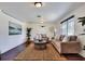 Cozy living room featuring hardwood floors, plush seating, and natural light, perfect for relaxation and entertaining at 1655 John Arthur Way, Lakeland, FL 33803