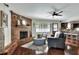 Stylish living room showcasing a brick fireplace, hardwood floors, and comfortable seating, creating a cozy ambiance at 1655 John Arthur Way, Lakeland, FL 33803