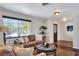 Comfortable living room with a large window, neutral color palette, and wood floors, creating an inviting atmosphere at 1655 John Arthur Way, Lakeland, FL 33803