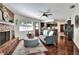 Inviting living room with a brick fireplace and warm hardwood floors at 1655 John Arthur Way, Lakeland, FL 33803