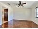 Bright living room featuring wood floors, ceiling fan, and view to hallway with tiled floors at 1655 John Arthur Way, Lakeland, FL 33803