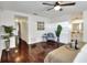 Bright main bedroom featuring hardwood floors, ceiling fan, bright natural light, and stylish decor at 1655 John Arthur Way, Lakeland, FL 33803