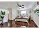 Beautiful main bedroom featuring hardwood floors, ceiling fan, bright natural light, and stylish decor at 1655 John Arthur Way, Lakeland, FL 33803