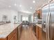 Bright kitchen featuring stainless steel appliances, granite countertops, and a view of the dining area at 1757 Burrows Ave, Lakeland, FL 33811