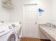 Efficient laundry room equipped with modern appliances and storage for convenience and organization at 1757 Burrows Ave, Lakeland, FL 33811