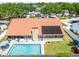 Aerial view of home with a pool, solar panels, and a tile roof at 1931 Matthew Ct, Lakeland, FL 33813