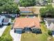 Aerial view of home showcasing a new roof, fenced yard, lush landscaping, and inviting curb appeal at 1931 Matthew Ct, Lakeland, FL 33813