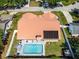 Aerial view of backyard featuring a sparkling pool, patio, solar panels and well-maintained lawn at 1931 Matthew Ct, Lakeland, FL 33813