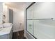 Bathroom featuring a modern vanity, vessel sink, and a tub with frosted sliding glass doors at 1931 Matthew Ct, Lakeland, FL 33813