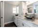 Elegant bathroom featuring double sinks with unique bowl design, granite countertops, and stylish white cabinetry at 1931 Matthew Ct, Lakeland, FL 33813