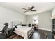 Bedroom with wood floors, ceiling fan, neutral walls, and modern decor with work space at 1931 Matthew Ct, Lakeland, FL 33813