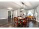Inviting dining room featuring hardwood floors, stylish curtains, and elegant light fixture at 1931 Matthew Ct, Lakeland, FL 33813