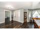 Welcoming foyer features dark wood laminate flooring, a classic dining room set and an entryway to the home gym at 1931 Matthew Ct, Lakeland, FL 33813