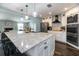 Open kitchen featuring a large island with seating and stainless steel appliances at 1931 Matthew Ct, Lakeland, FL 33813