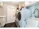 Bright laundry room features modern washer, dryer, utility sink, and counter space at 1931 Matthew Ct, Lakeland, FL 33813