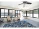 Bright sun room with multiple windows, ceiling fan, and access to the backyard pool at 1931 Matthew Ct, Lakeland, FL 33813